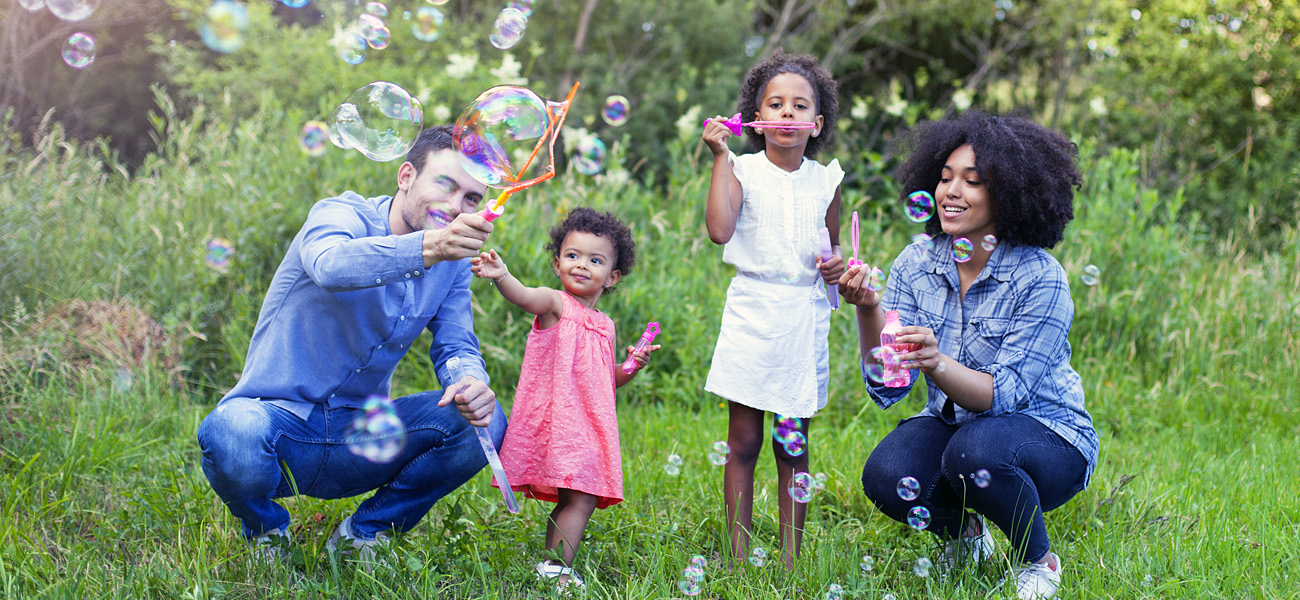 Happy Family Blowing Bubbles - Family Preservation Foundation